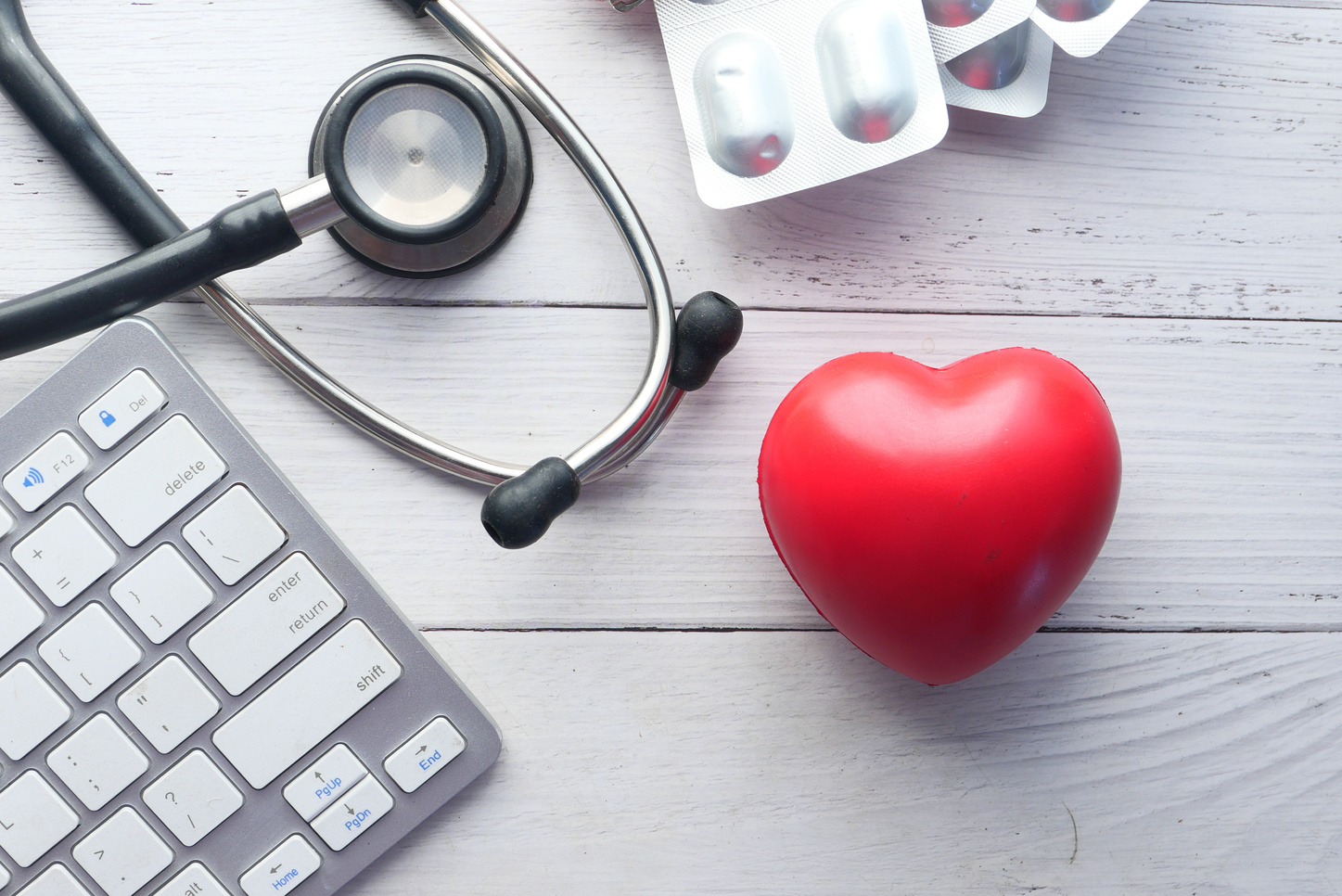 Keyboard, Heart, and Stethoscope on White Background
